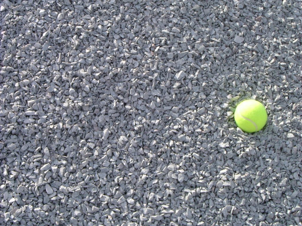 Light gray colored limestone with a yellow tennis ball for scale