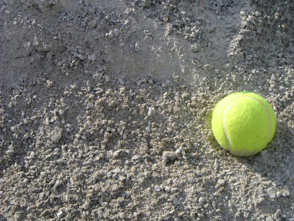Light gray colored limestone with a yellow tennis ball for scale