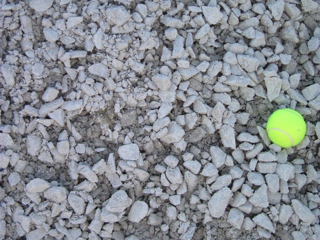White to gray limestone with a yellow tennis ball for scale