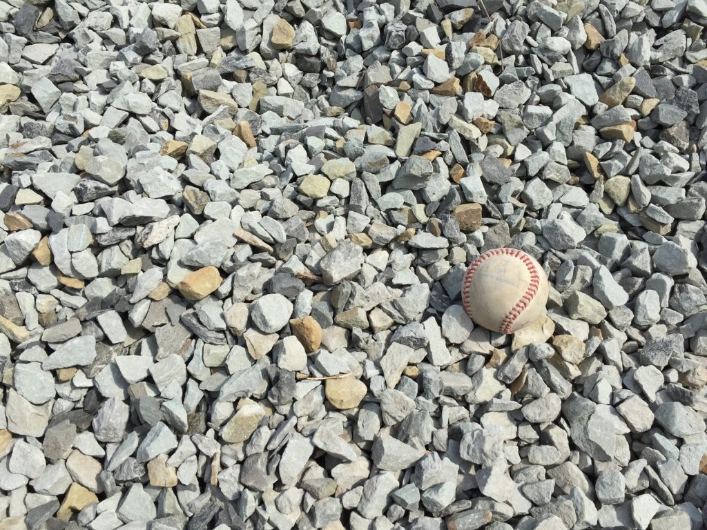 Light gray colored limestone with a white baseball for scale