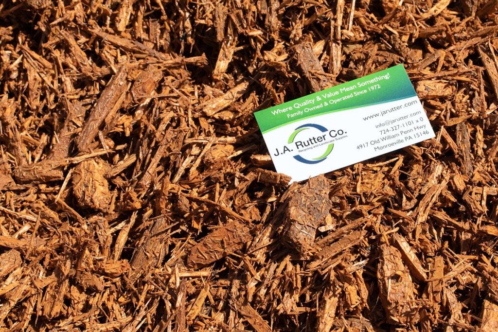 Green and white business card of J.A. Rutter Co. on top of Saffron Mulch