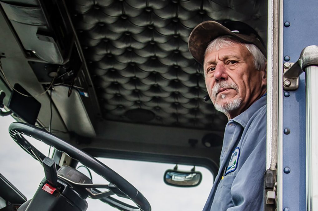 Man looking out of semi-truck cab